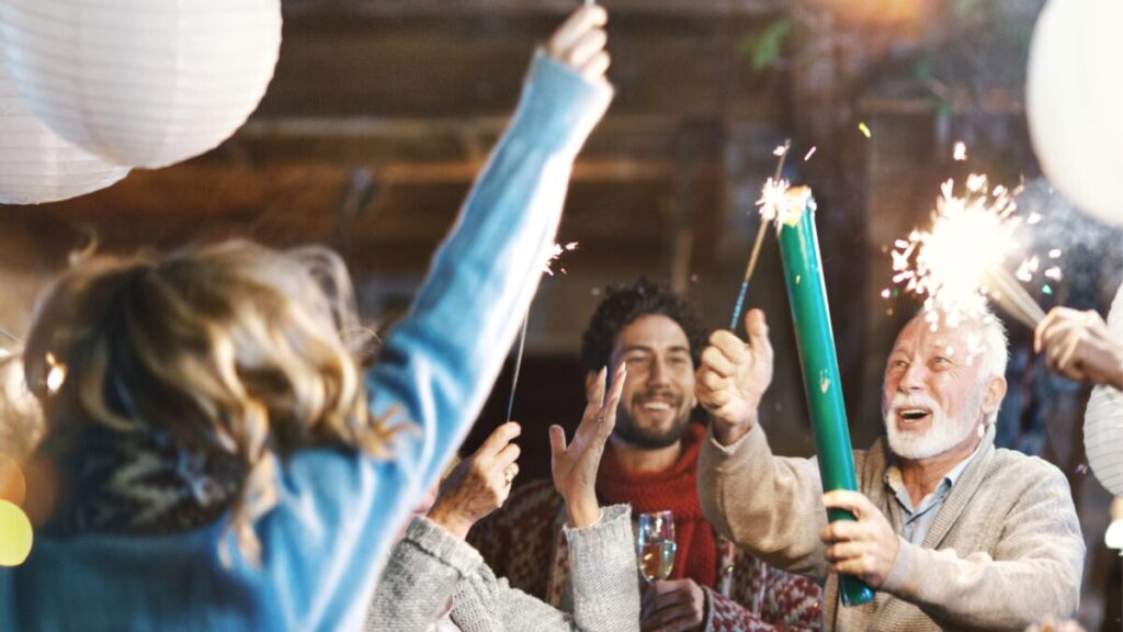 A group of people light sparklers